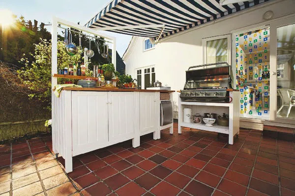 Самое практичное решение - расположить летнюю кухню рядом с домом
